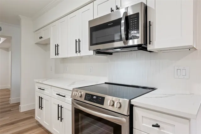 a kitchen with a stove and a microwave