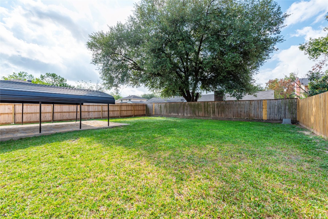 4315 Brookhead Trail Houston, TX 77066 - Photo 29 of 29 a view of a yard with a large tree and a wooden fence