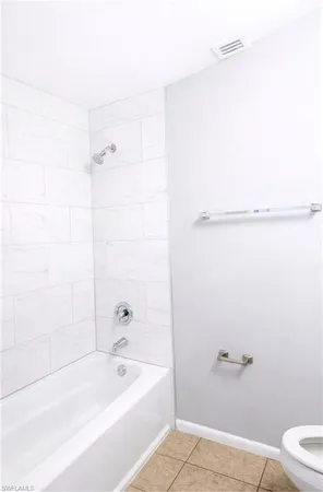 a bathroom with a bathtub and shower