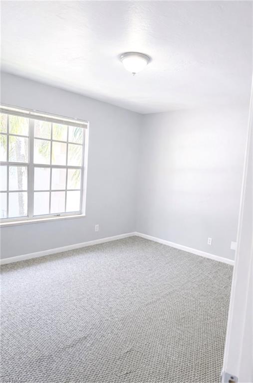 5364 16th Place Southwest, Unit H3 Naples, FL 34116 - Photo 7 of 8 Spare room with carpet flooring and baseboards