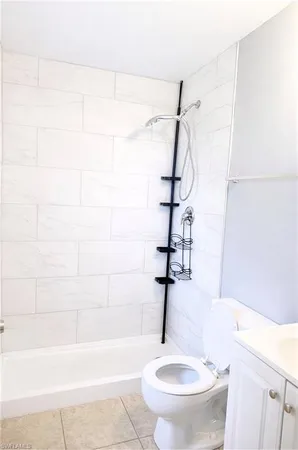 a bathroom with a shower a toilet and a shower