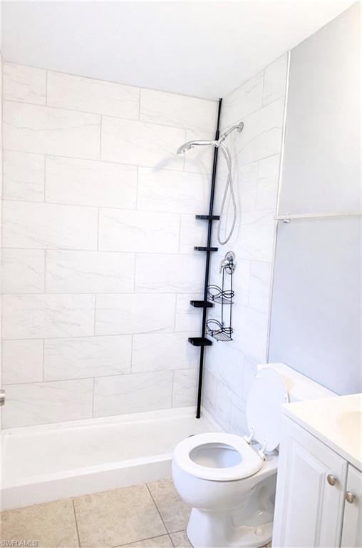 5364 16th Place Southwest, Unit H3 Naples, FL 34116 - Photo 8 of 8 Bathroom featuring tiled shower, vanity, and light tile patterned floors