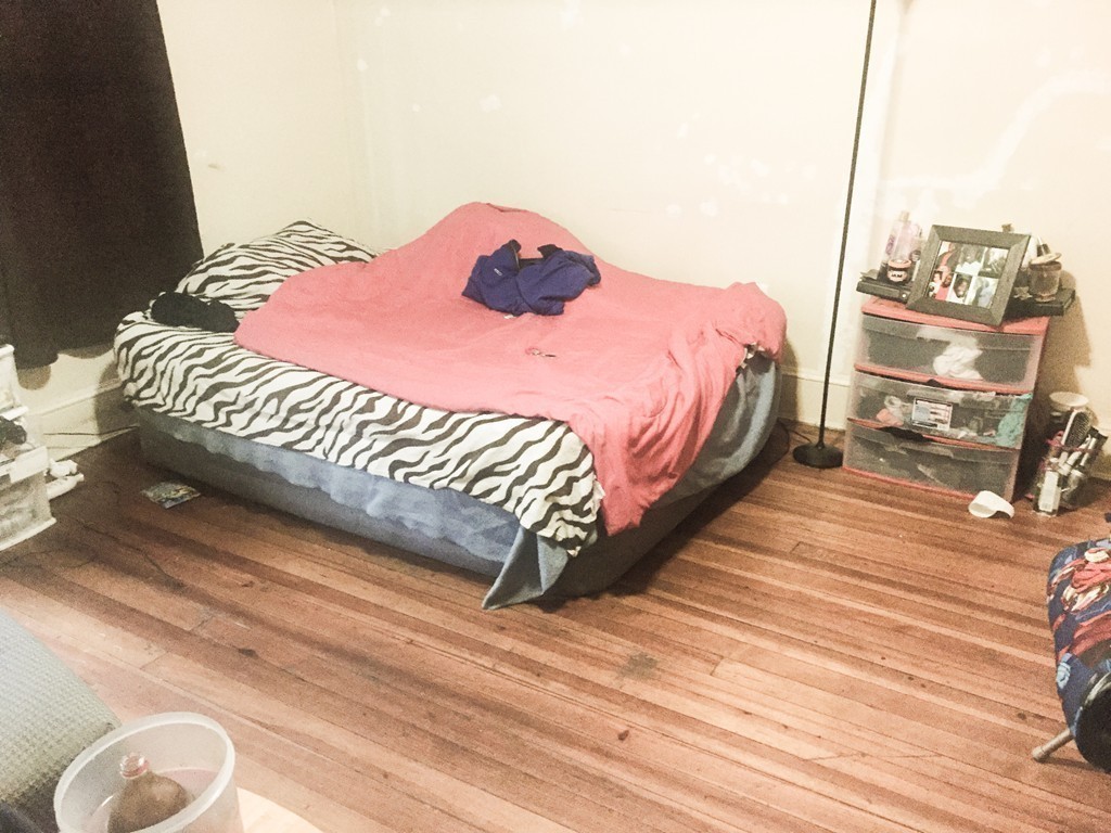 9 Leete Street Springfield, MA 01108 - Photo 19 of 23 a bed sitting in a bedroom next to a window