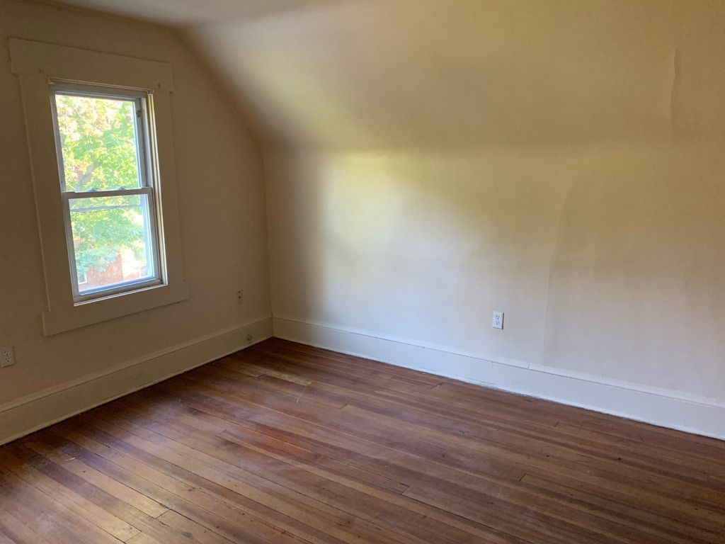 9 Leete Street Springfield, MA 01108 - Photo 10 of 23 a view of an empty room with wooden floor and a window