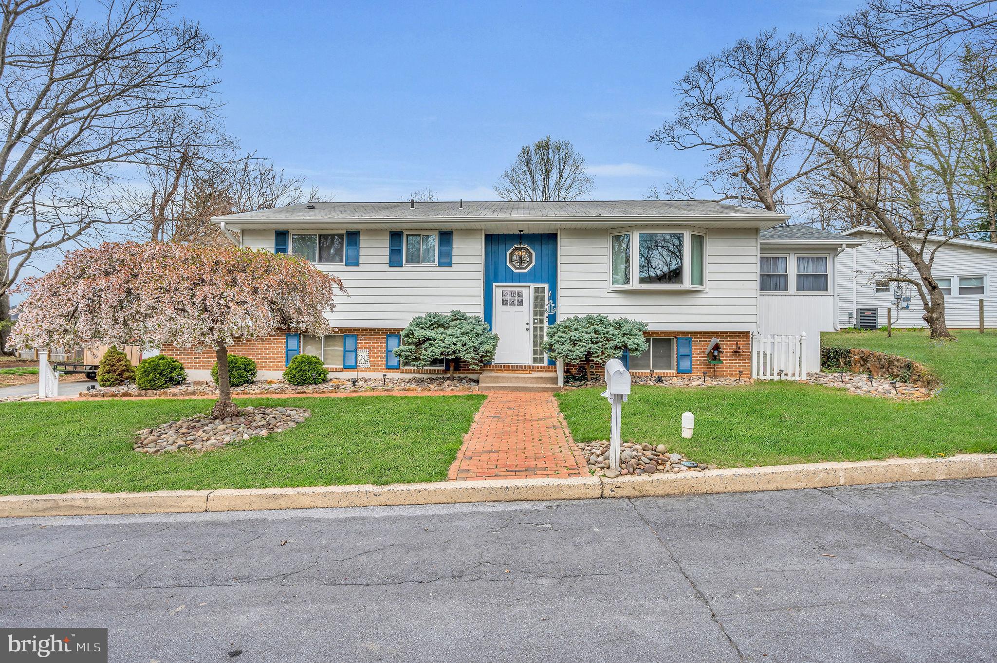 a front view of house with yard and green space