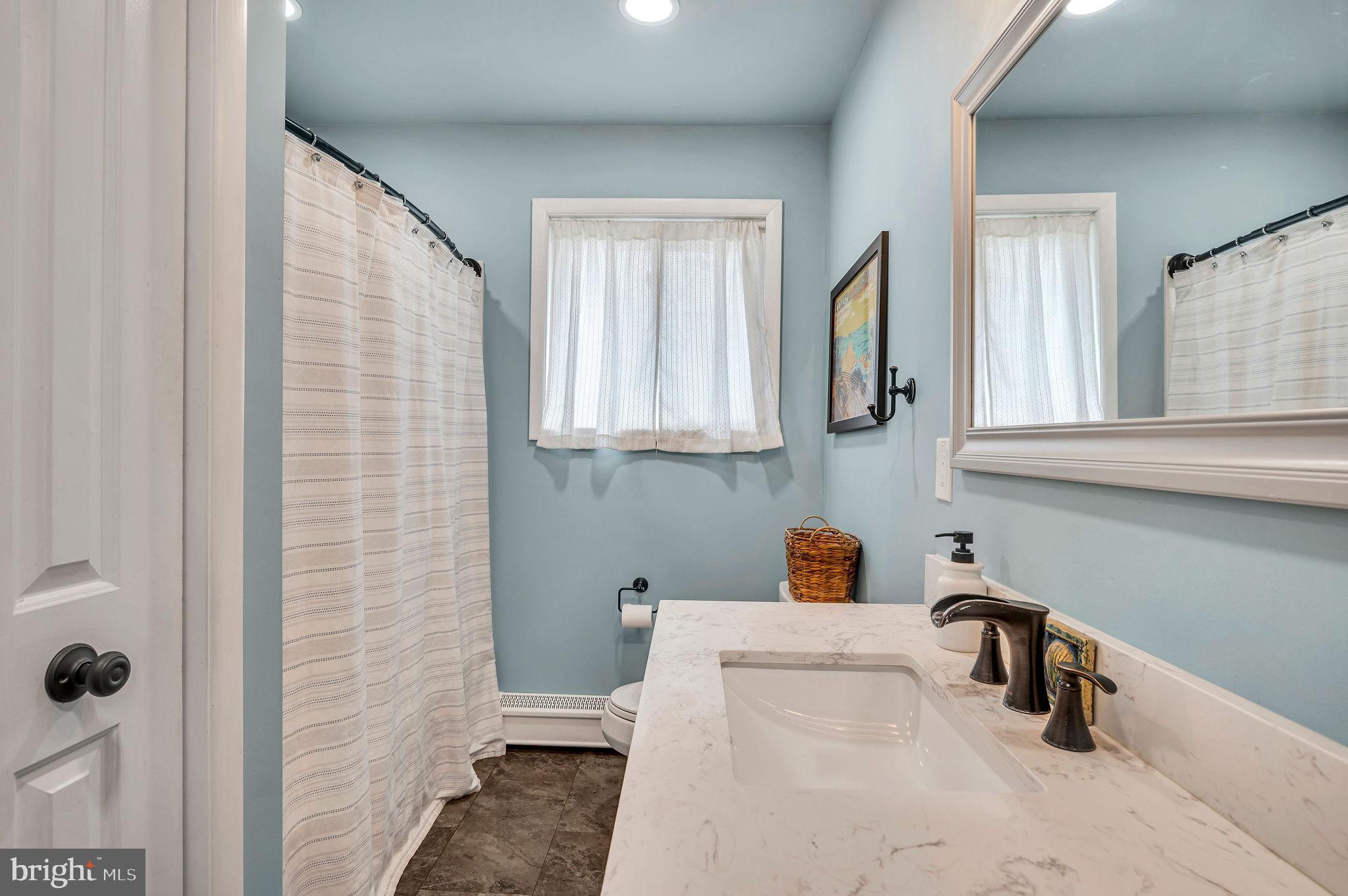 2707 Broder Street Southwest Allentown, PA 18103 - Photo 14 of 32 a bathroom with a sink and a mirror