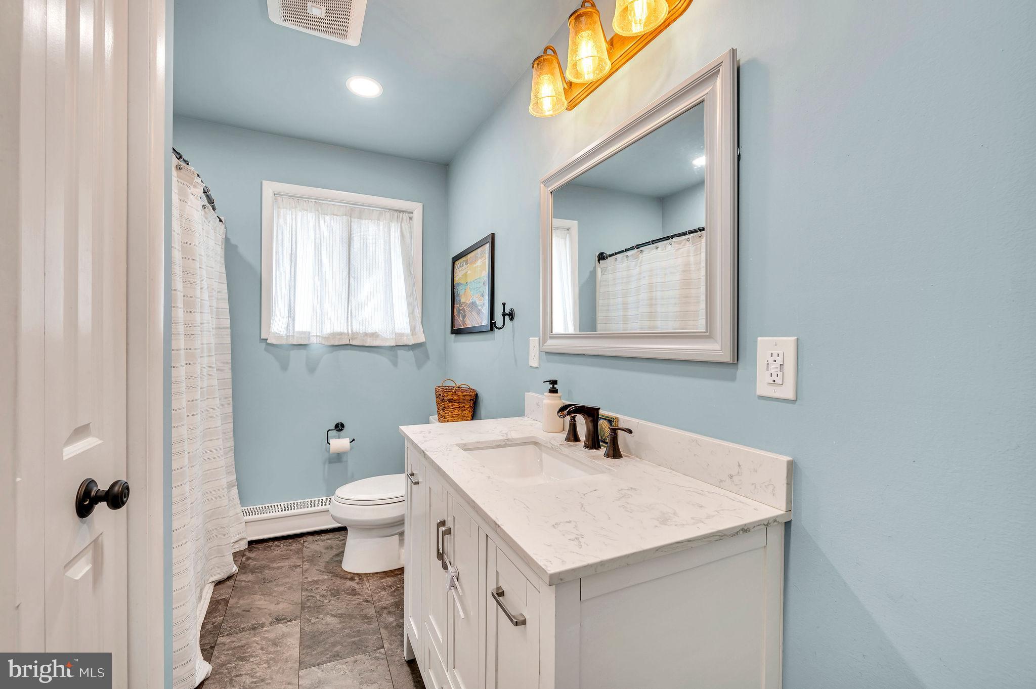 2707 Broder Street Southwest Allentown, PA 18103 - Photo 15 of 32 a bathroom with a sink and mirror with toilet