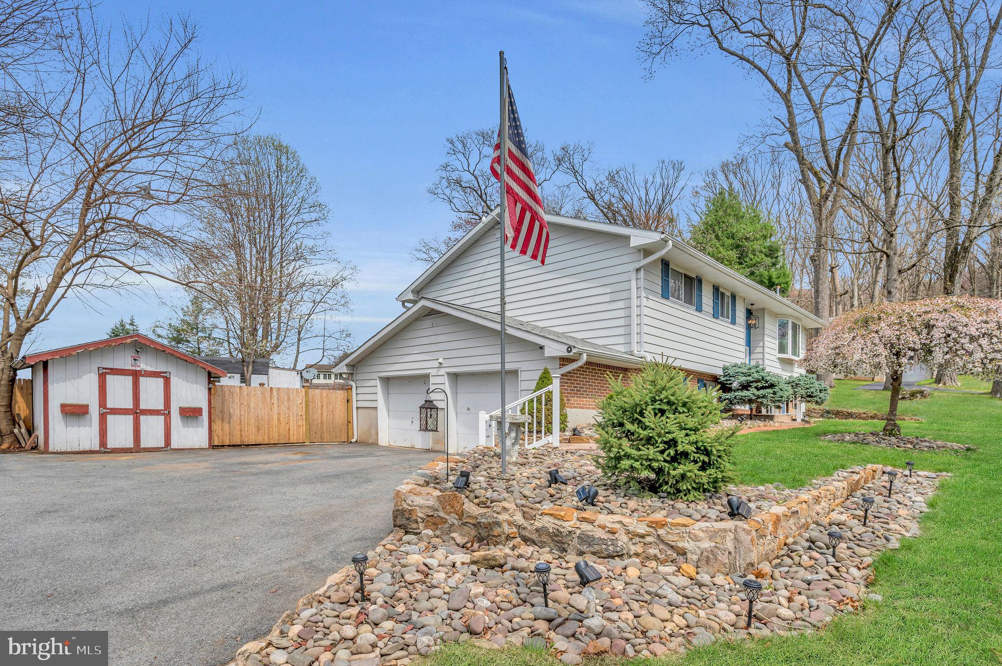 2707 Broder Street Southwest Allentown, PA 18103 - Photo 3 of 32 a front view of a house with a garden and trees