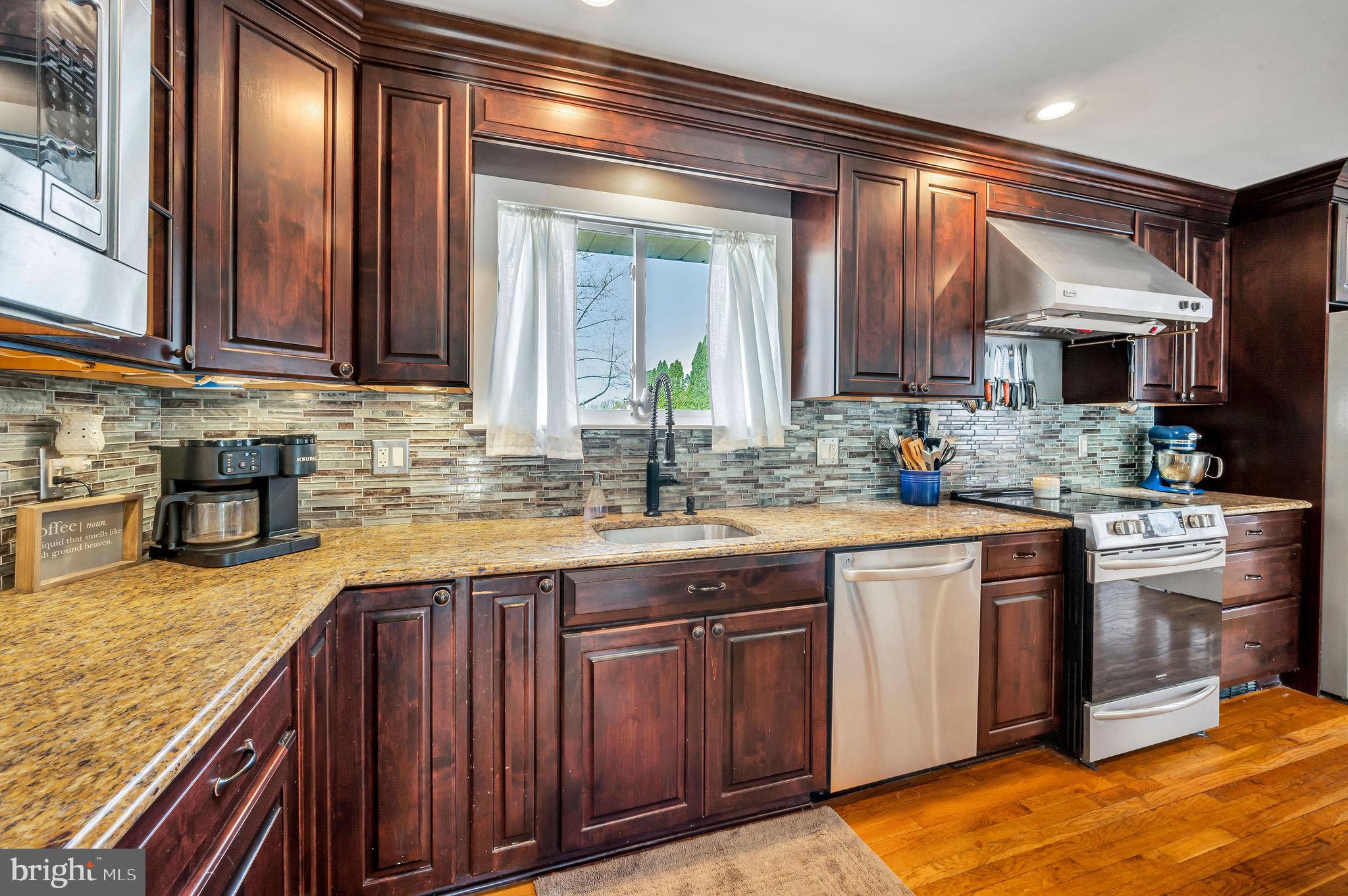 2707 Broder Street Southwest Allentown, PA 18103 - Photo 8 of 32 a kitchen with stainless steel appliances granite countertop a sink and stove top oven