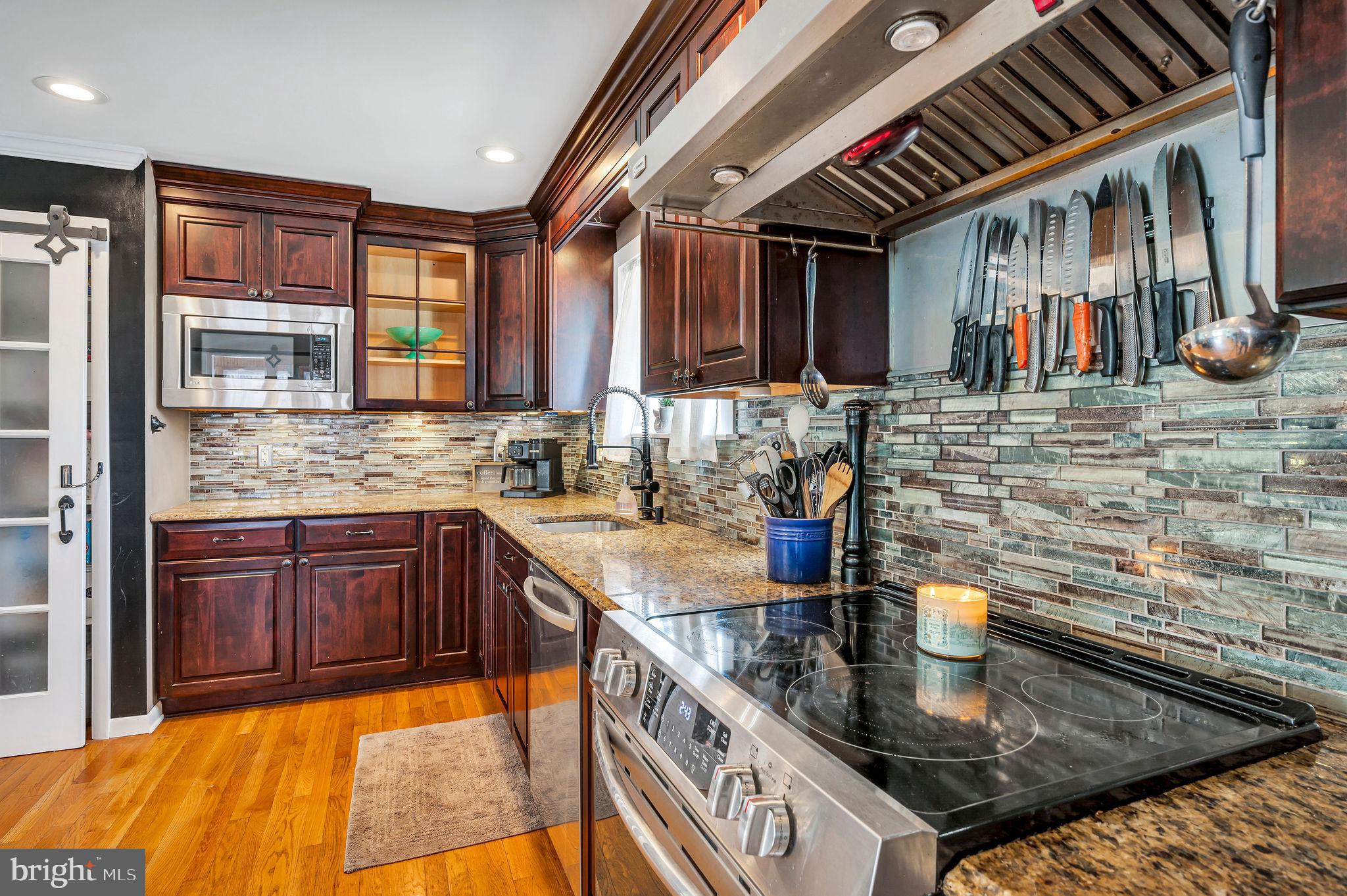 2707 Broder Street Southwest Allentown, PA 18103 - Photo 9 of 32 a kitchen with stainless steel appliances granite countertop a sink stove and cabinets