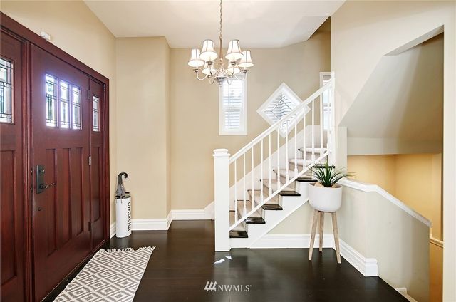 a view of entryway and hall with wooden floor