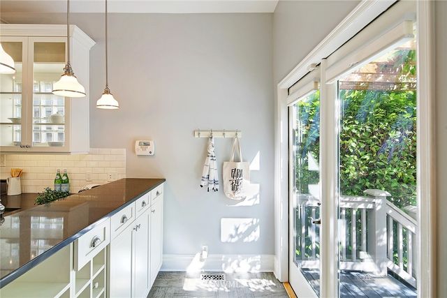a kitchen with granite countertop a sink and a large window