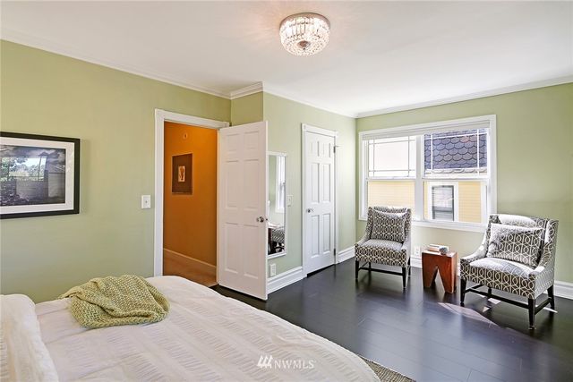 a bedroom with a bed and a couch next to a window