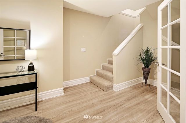 a view of an entryway with wooden floor and front door