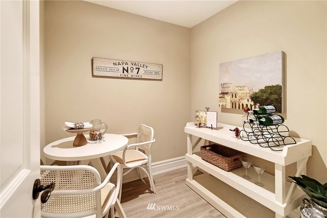 a view of a dining room with furniture and chandelier