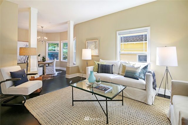 a living room with furniture and a lamp