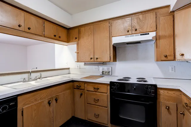 a kitchen with stainless steel appliances granite countertop a sink stove and cabinets