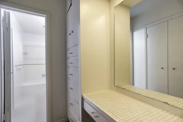 a bathroom with a granite countertop sink and a mirror