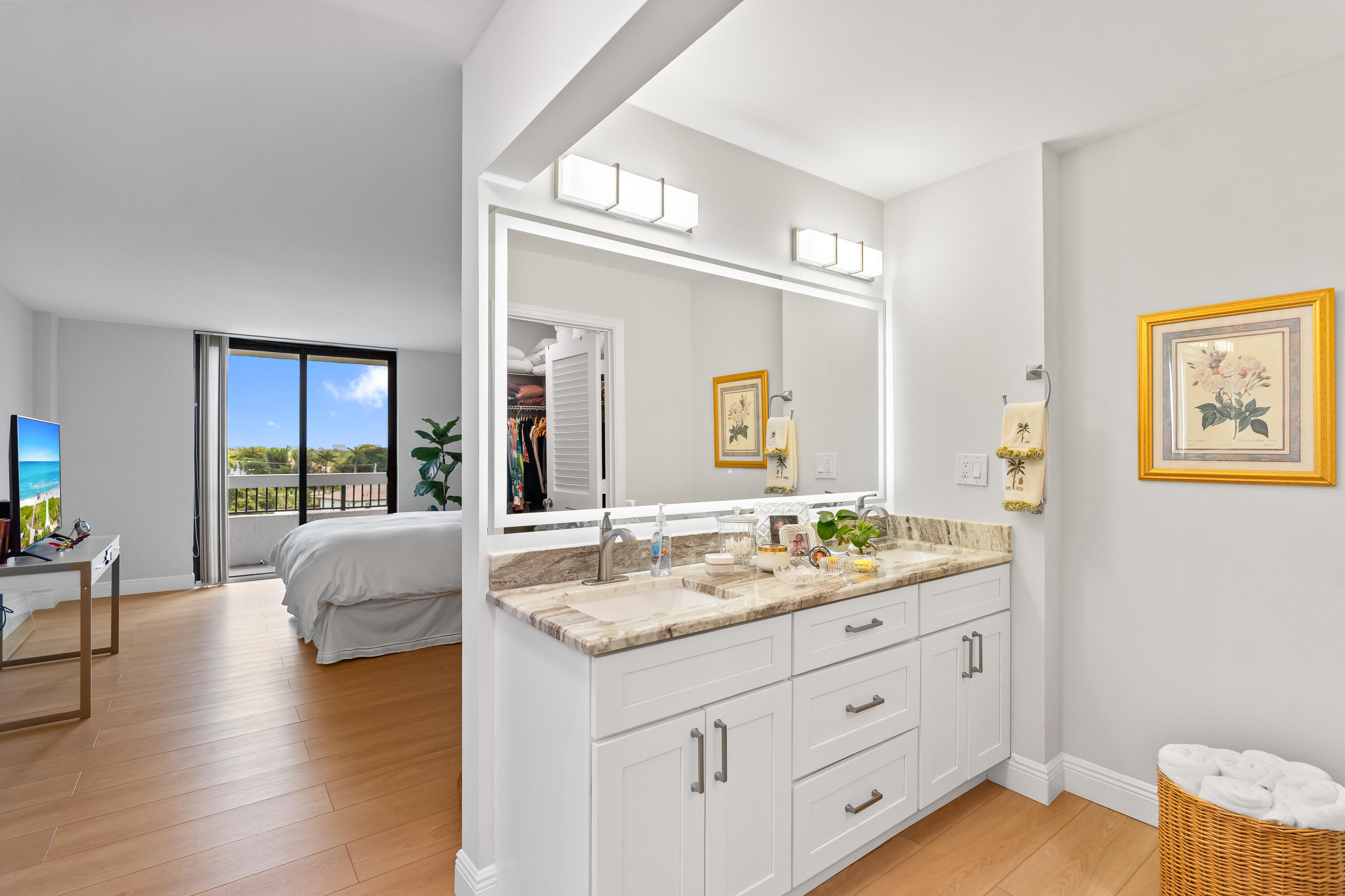 23200 Camino Del Mar, Unit 603 Boca Raton, FL 33433 - Photo 19 of 43 a spacious bathroom with a granite countertop sink and a large mirror