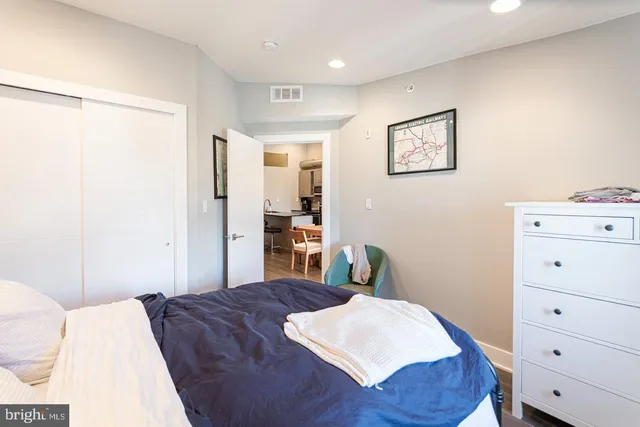 a bedroom with a bed and a dresser