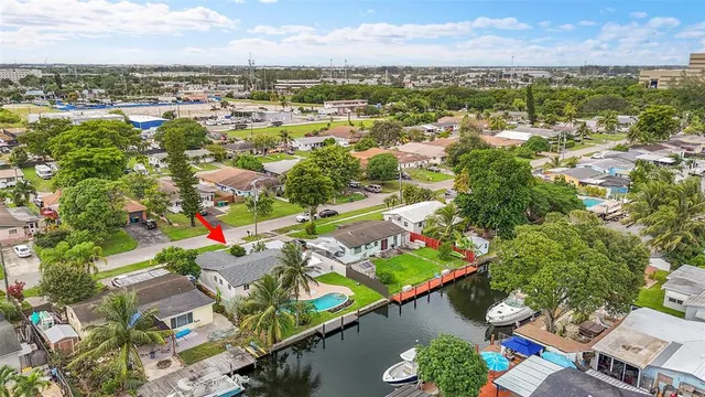 an aerial view of a city with lots of residential buildings ocean and mountain view in back