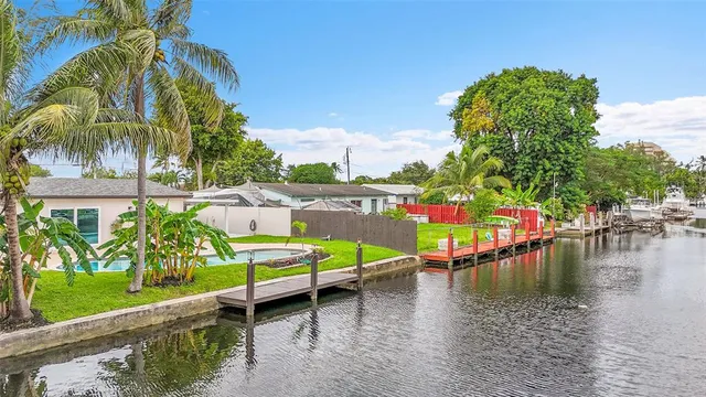 a view of a swimming pool with a bench and trees
