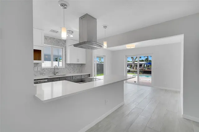 a large kitchen with granite countertop a large counter top space a sink and appliances