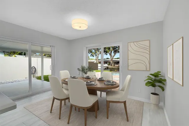 a view of a dining room with furniture and a potted plant