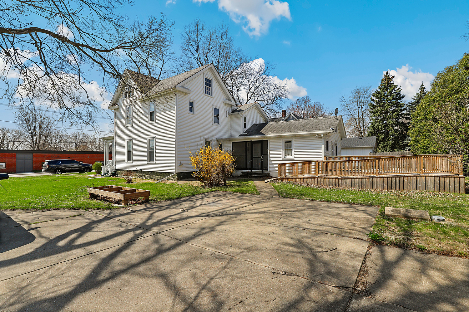 309 East 3rd Street Sandwich, IL 60548 - Photo 29 of 33 a view of a white house with a big yard and large trees