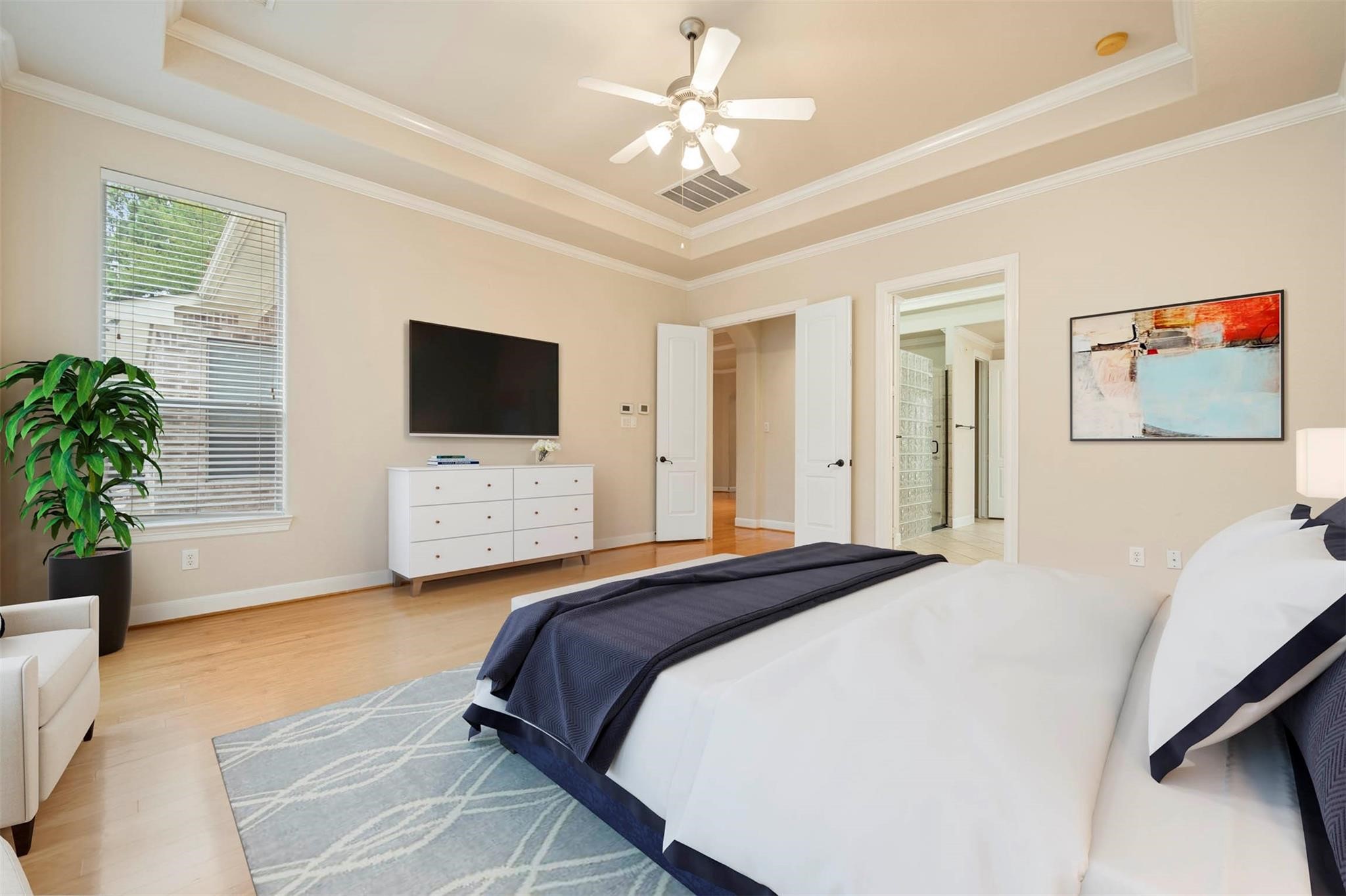 3 Etude Court Spring, TX 77382 - Photo 18 of 45 a bedroom with a large bed and a flat screen tv