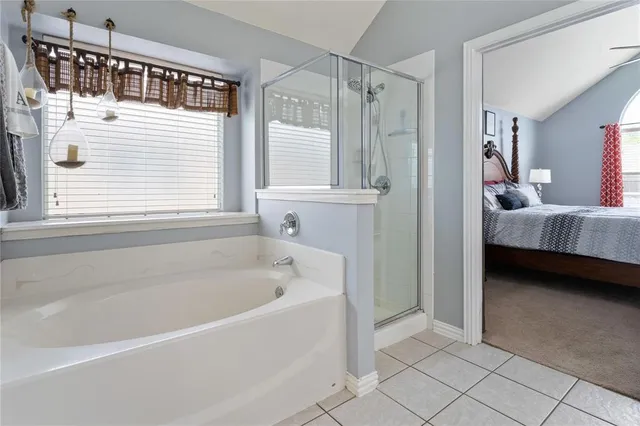 a bathroom with a tub and a view of bathroom