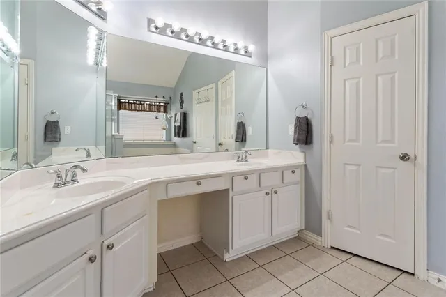 a bathroom with a sink double vanity and a mirror