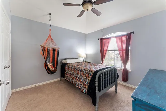 a bedroom with a bed and window