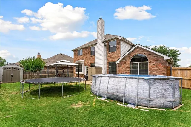 a front view of a house with a yard table and chairs