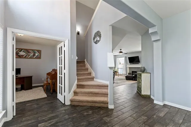 a view of a hallway with wooden floor and a living room