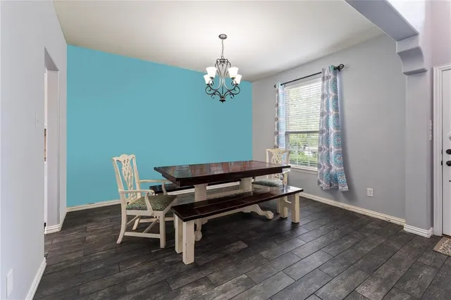 a sitting area with wooden floor and pool table