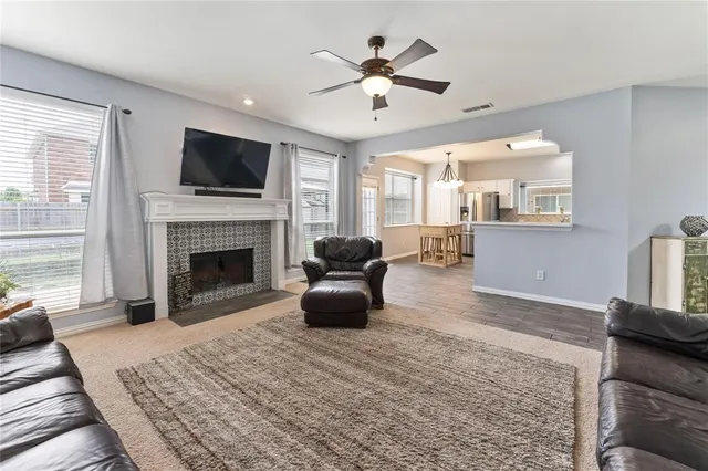 a living room with furniture a flat screen tv and a fireplace