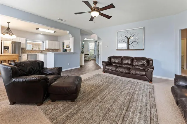 a living room with furniture and a wooden floor