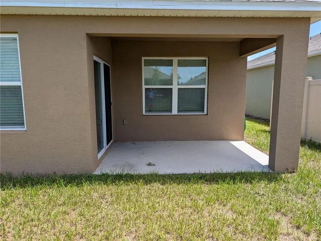 a view of house with backyard