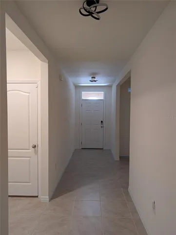 a view of a room with a projector and wall