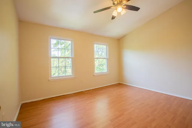 a view of a room with wooden floor and windows