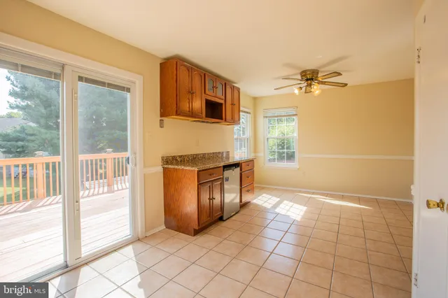 a kitchen with stainless steel appliances granite countertop a refrigerator sink and microwave