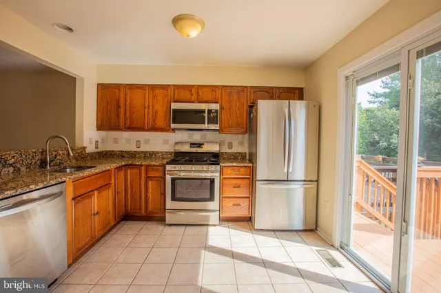 a kitchen with stainless steel appliances granite countertop a stove and a refrigerator