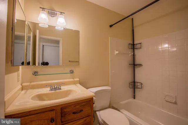 a bathroom with a sink toilet and mirror