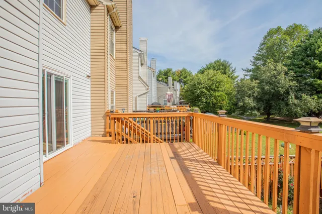 a balcony with wooden floor and fence