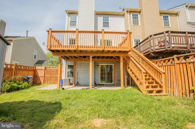 a view of a house with a yard and deck