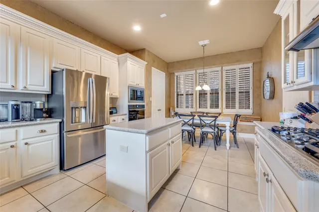 a kitchen with granite countertop cabinets and stainless steel appliances