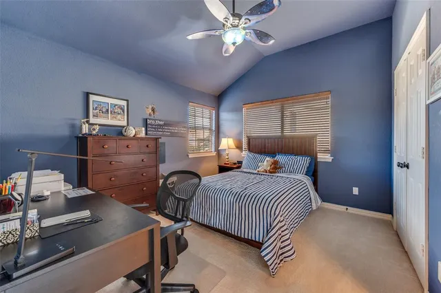a bedroom with two beds and a chandelier
