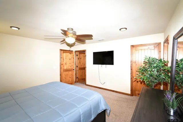 a bedroom with a bed and a flat screen tv