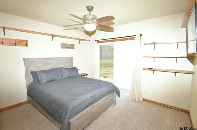 a bedroom with a large bed and a chandelier